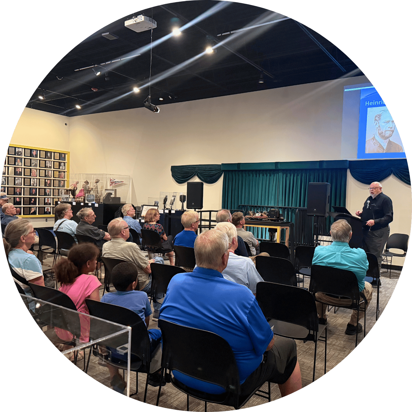 museum guests watching public speaker